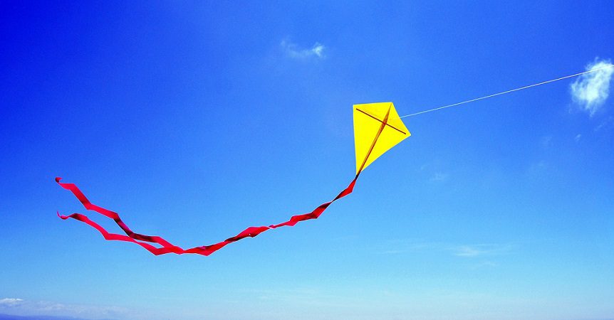 Yellow kite flying in the sky